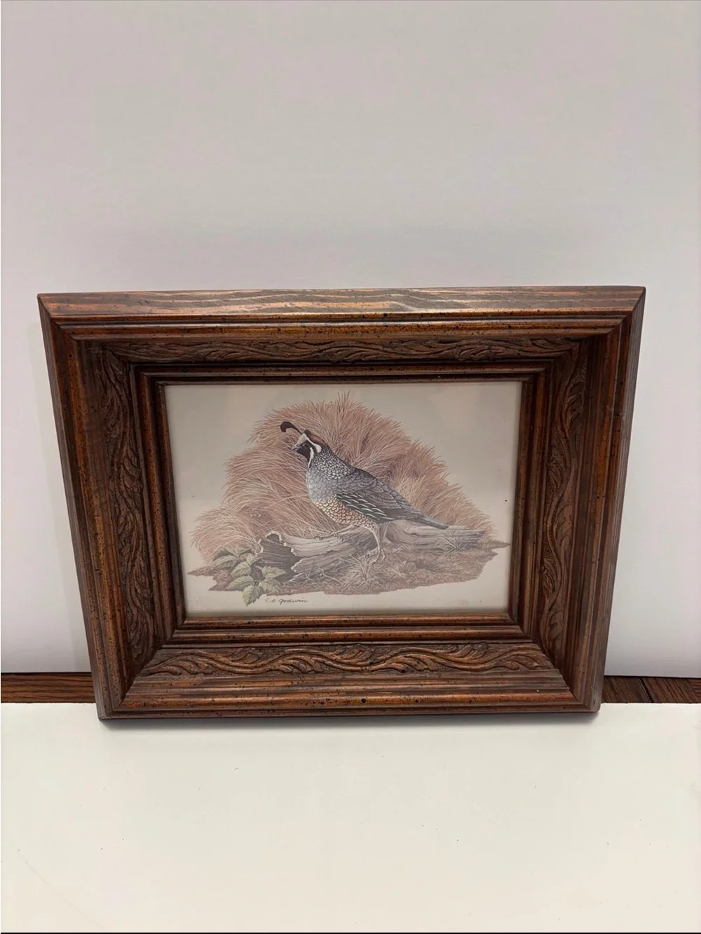 Vintage quail wall art with a rustic, carved wood frame